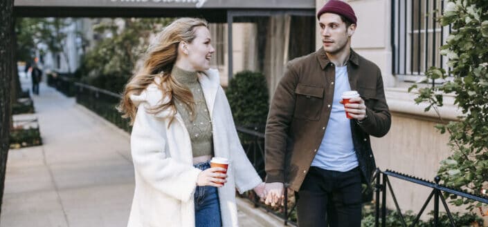 Couple walking on the sidewalk while holding hands