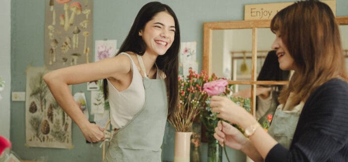 laughing women having conversation in flower shop