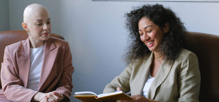 female sharing something funny to her colleague