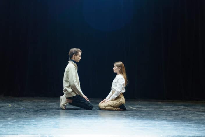 man and woman sitting on floor