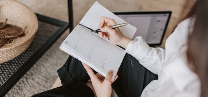 woman writing on a journal
