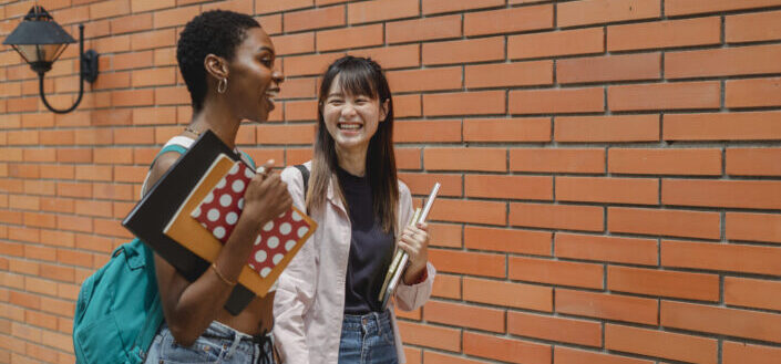 young students talking after lecture