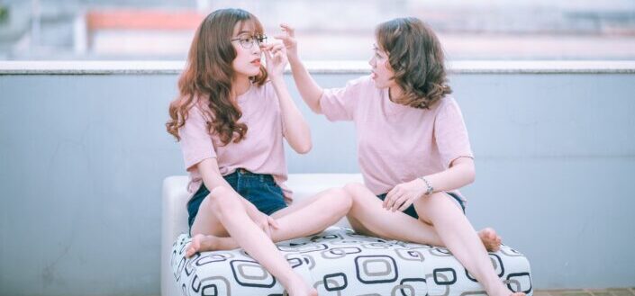 two women taking selfie indoors
