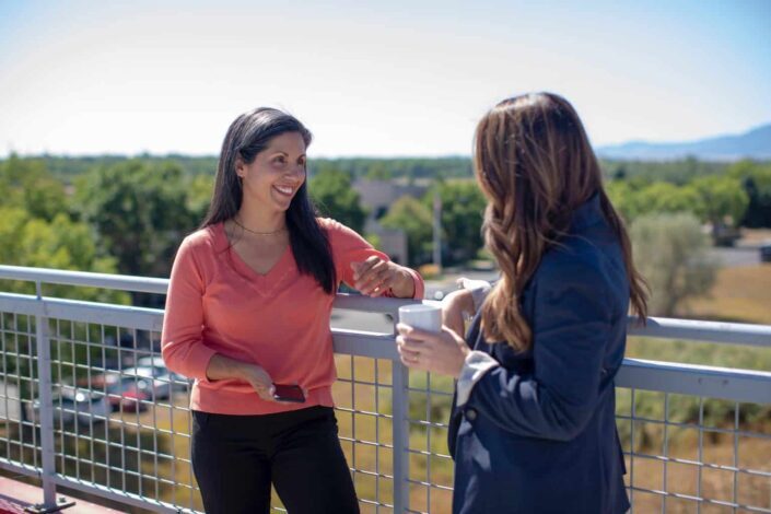 women standing beside railings during daytime