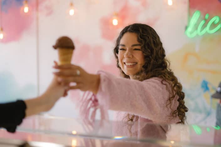 happy woman ordering a chocolate ice cream