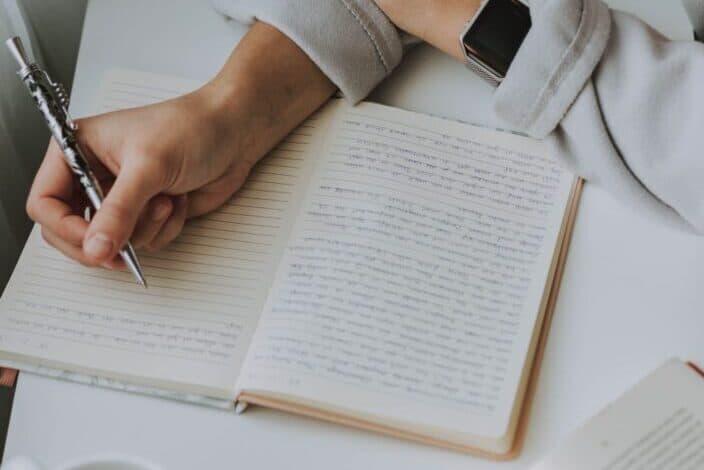 writing on a notebook