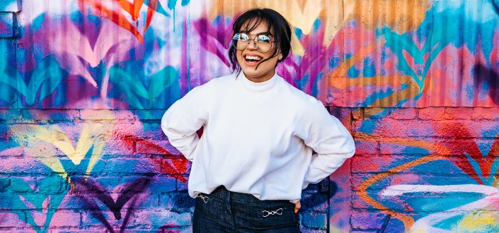woman standing in front of multicolored wall