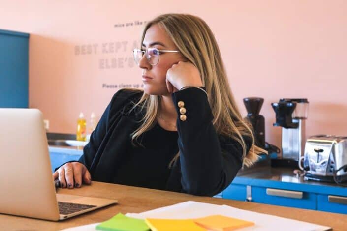 woman with eye glasses using laptop