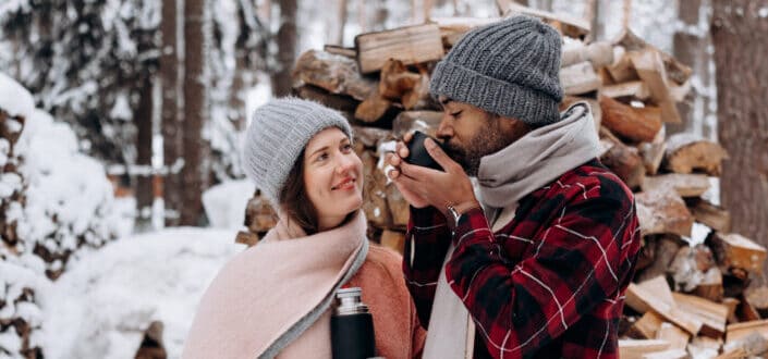 couple drinking coffee at snow