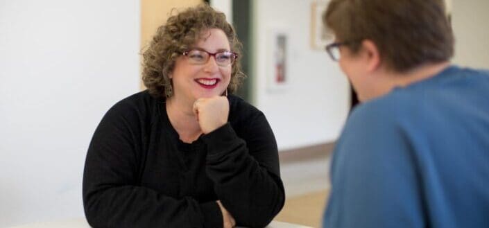 Happy woman looking at coworker