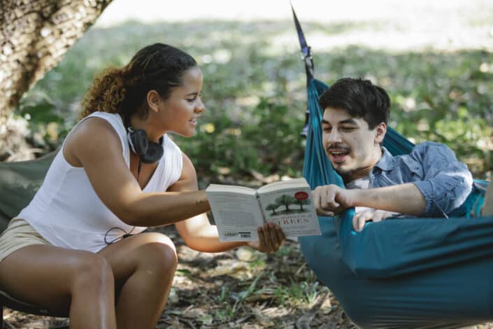 Woman sharing book to her boyfriend