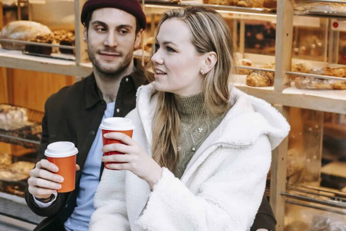 Smiling couple enjoying their coffee in a coffeeshop
