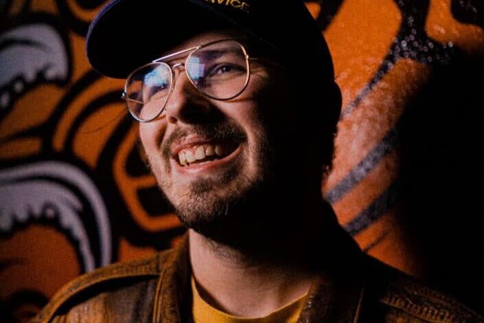 smiling man wearing cap and glasses