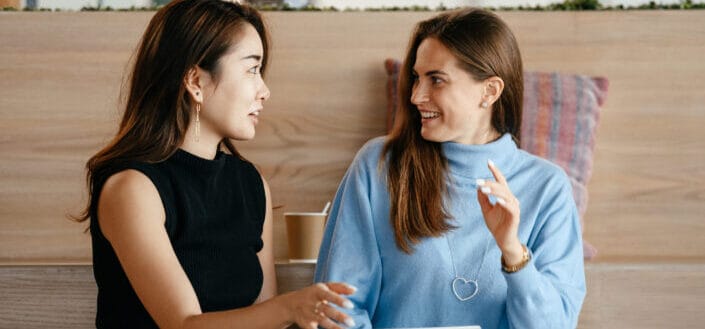 two middle aged women talking to each other