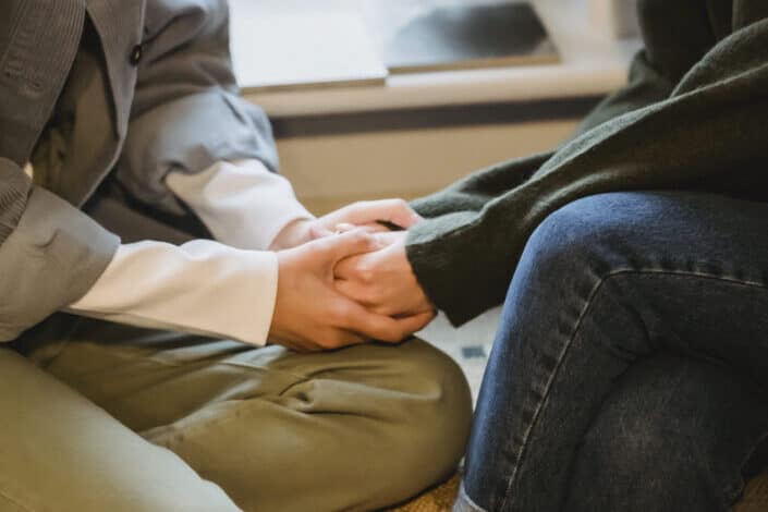 two people comforting each other