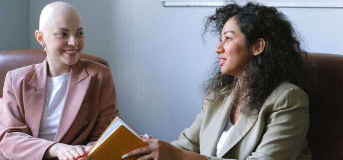 two smiling women having deep talks