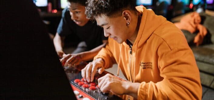Two men playing an arcade video game