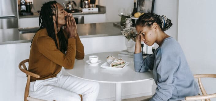 couple arguing at kitchen table