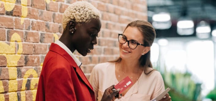 two professional looking women discussing over something