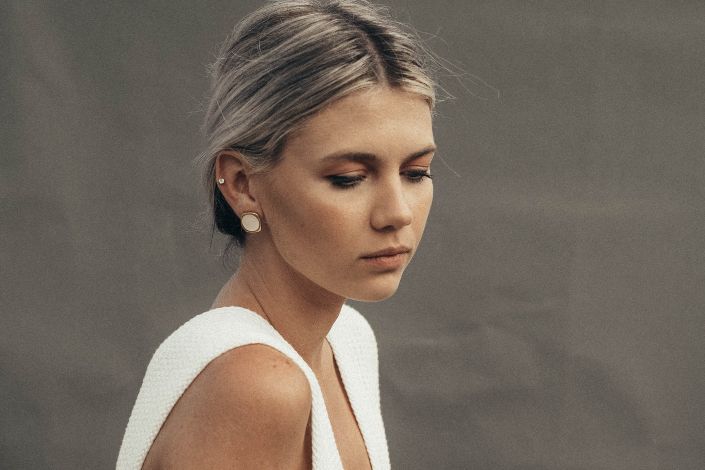 pensive-female-sitting-on-stool-stockpack-pexels