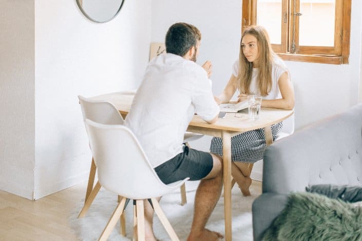 man-and-woman-sitting-at-table-near-window-pexels-nataliya-vaitkevich