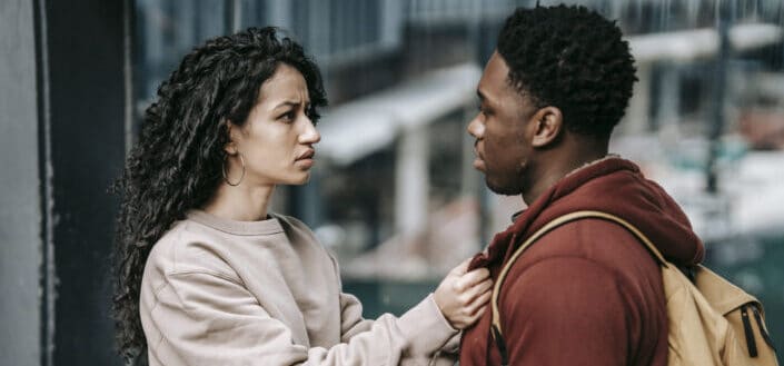 young couple fighting on street
