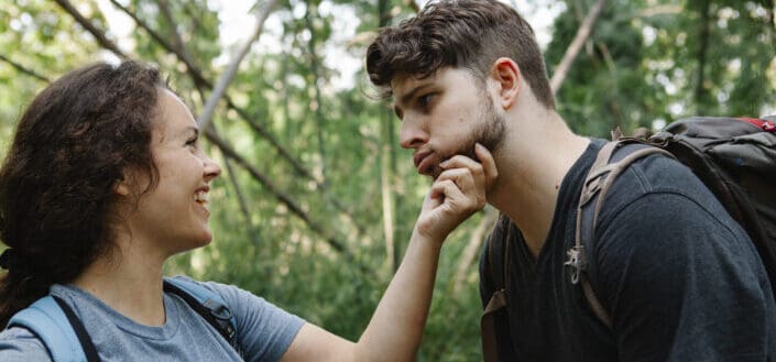 couple having fun during trekking in woods