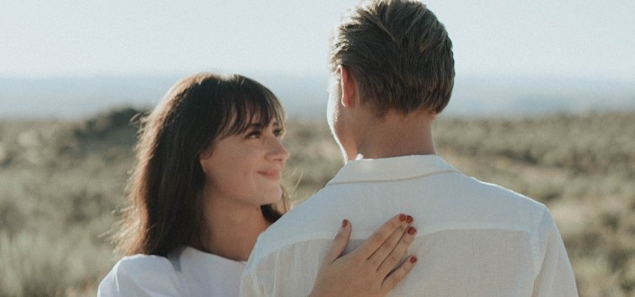 happy woman hugging his man in a field