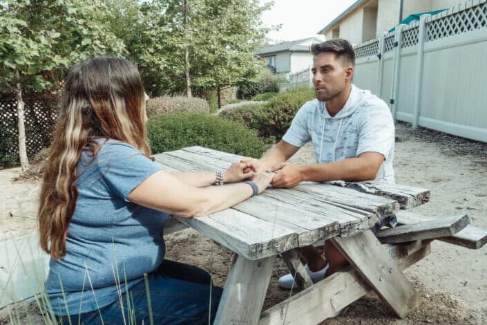 couple sitting on picnic table