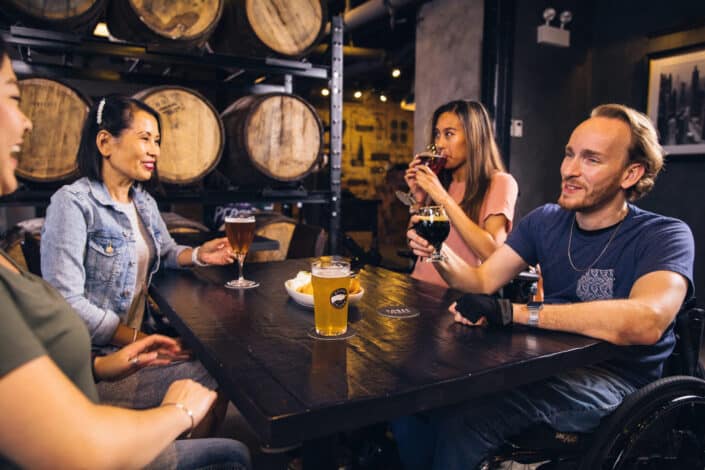Four friends drinking a variety of beer and wine