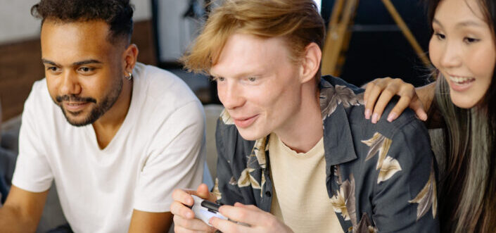 Three friends playing a video game.