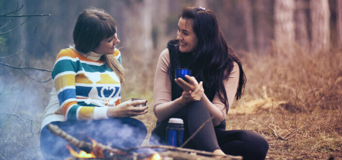 Two female friends having a deep conversation in the forest.