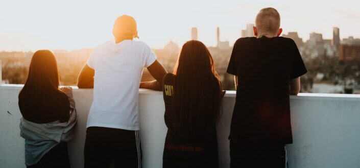 four person looking at the city