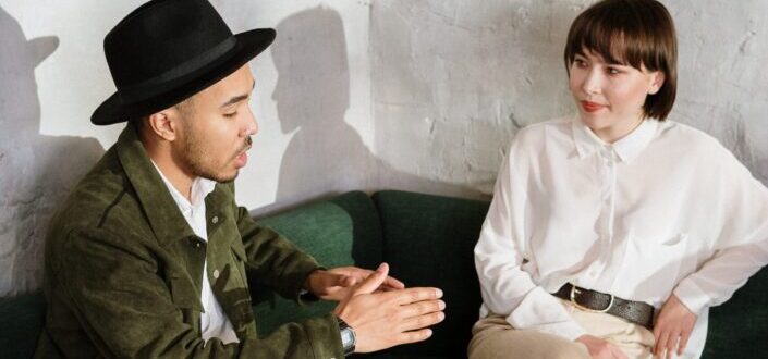 2 people Sitting on Green Couch
