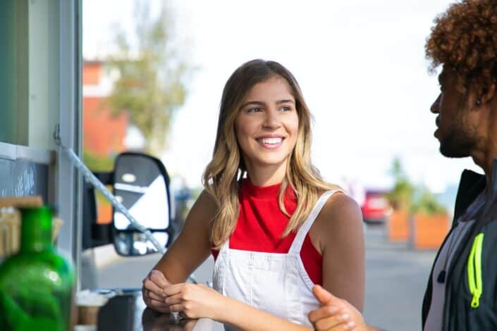 female talking to boyfriend near food truck