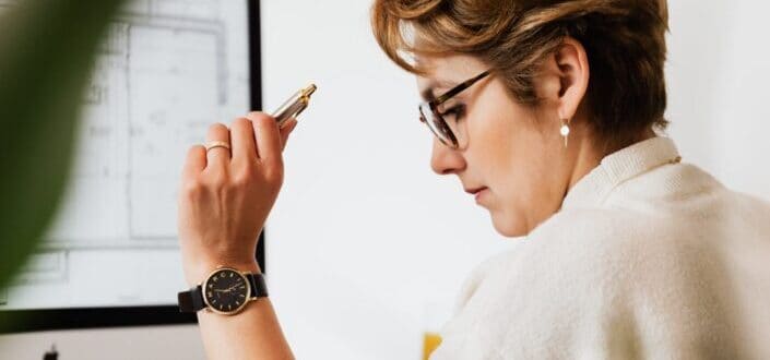 businesswoman reading documents and working on computer