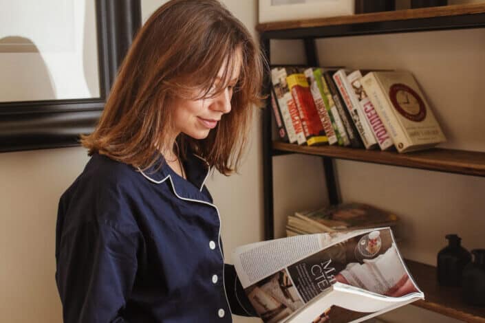 A woman reading a magazine.