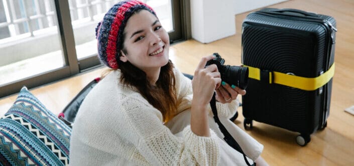 Happy woman holding a camera