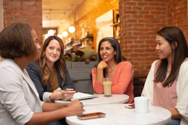 women talking while having snacks - alpha female