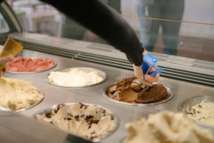 Cropped hand scooping ice cream
