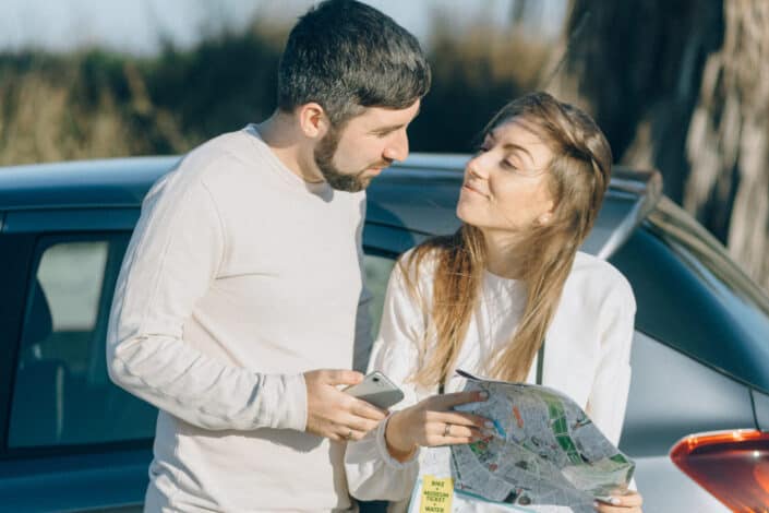 Couple on stopover, checking a map together.