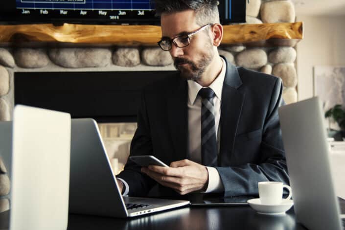 Man holding his phone while working