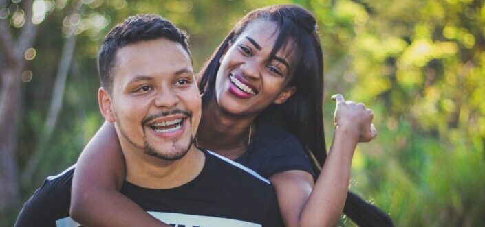Man giving her girl a piggyback ride
