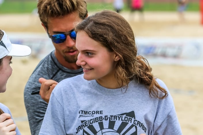 volleyball player getting signed up in her shirt