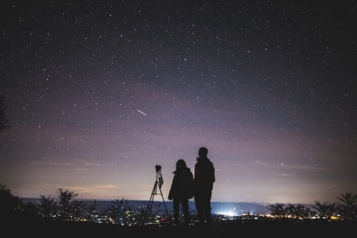 Silhouette of Two Persons Stargazing