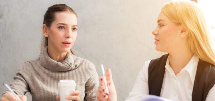 Two women asking each other questions