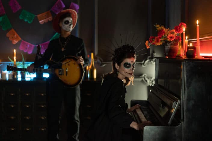 Two zombie-attired people playing instruments.
