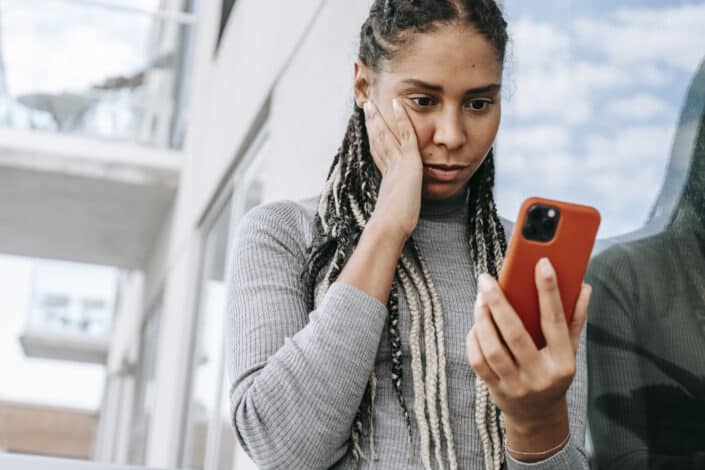 Woman a bit elated while checking her phone.