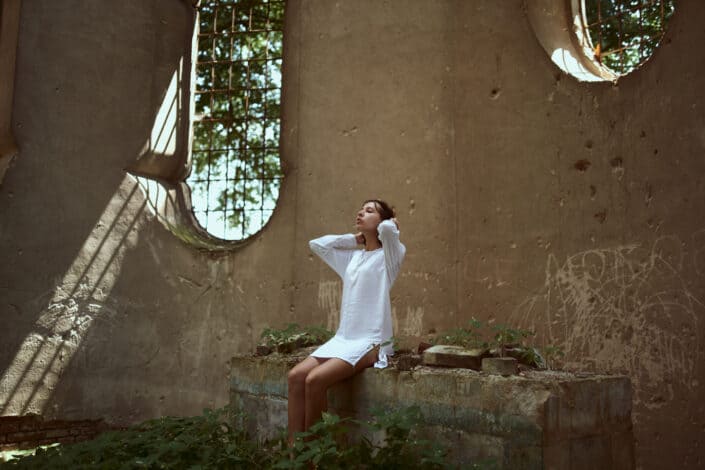 Woman contemplating on a walled shelter 