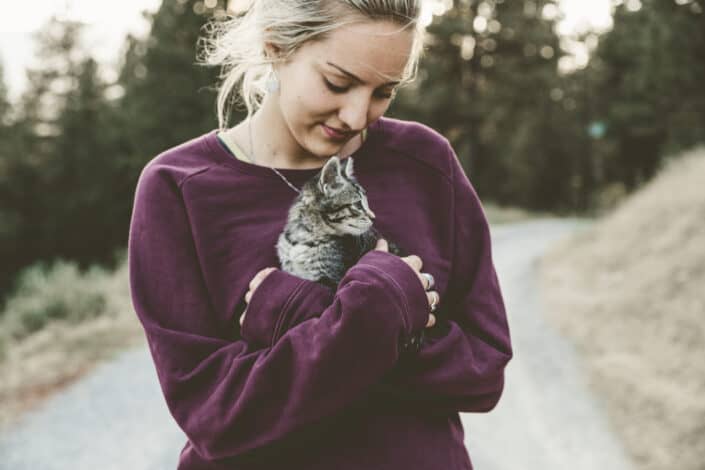 Woman cuddling a kitten
